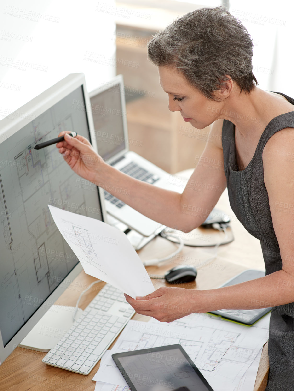 Buy stock photo Architecture, woman and drawing on computer screen with paper, housing development and reference in office. Architect, blueprint and tech in firm for digital plan, innovation and project management