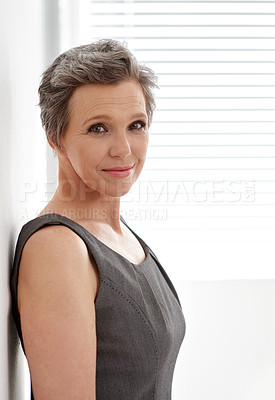 Buy stock photo Happy, mature and portrait of business woman at window in office for professional career. Corporate, leaning and wall with confident employee person in company workplace for ambition or mission