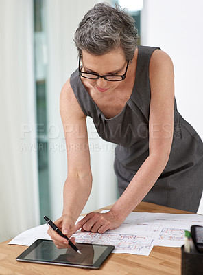 Buy stock photo Woman, architect and blueprint with drawing, tablet or review with reading, property or project in office. Mature person, floor plan or touchscreen for design, sketch and development for real estate