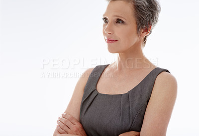 Buy stock photo A mature businesswoman looking away thoughtfully against a white background