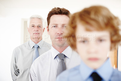 Buy stock photo Cropped portrait of a handsome man standing with his father and his son