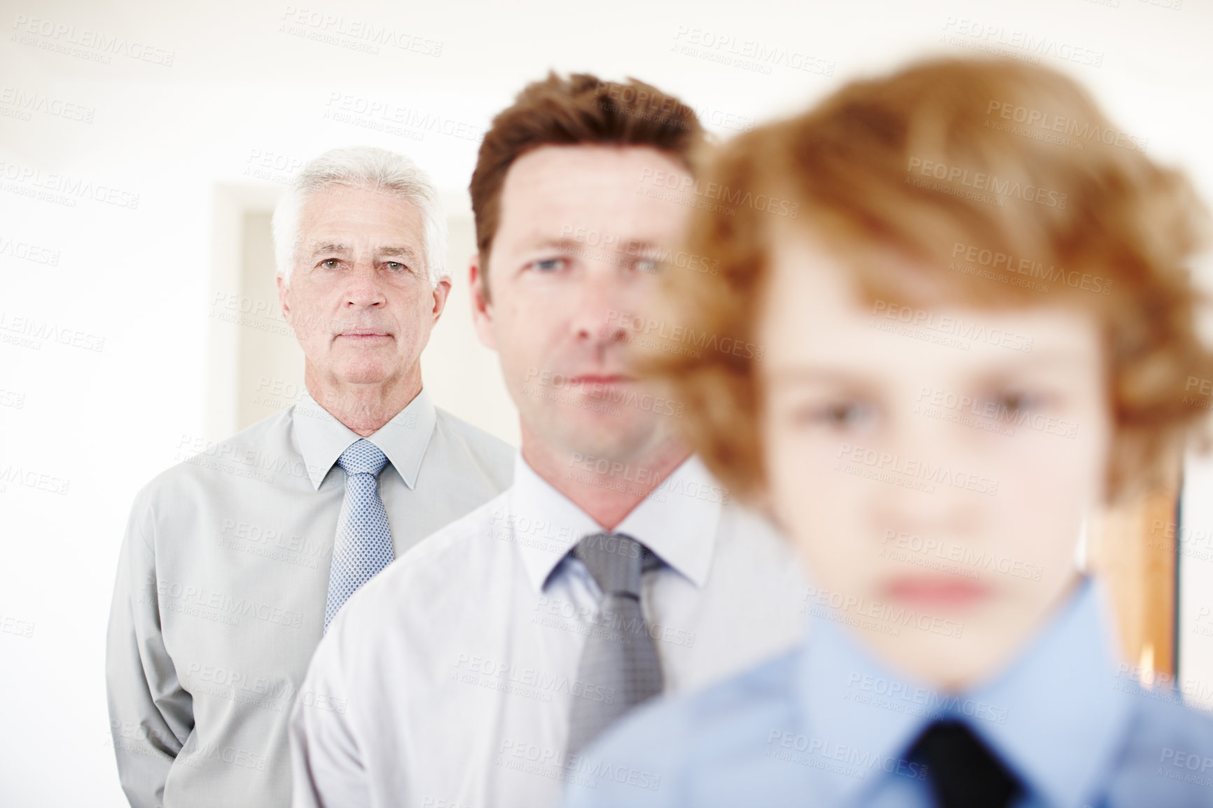 Buy stock photo Cropped portrait of a handsome man standing with his father and his son