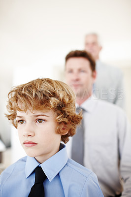 Buy stock photo Boy, face and serious in home with family, bonding and generations together or love. Unhappy male person, son and tough kid for child development, heir and inheritance in childhood or people in house
