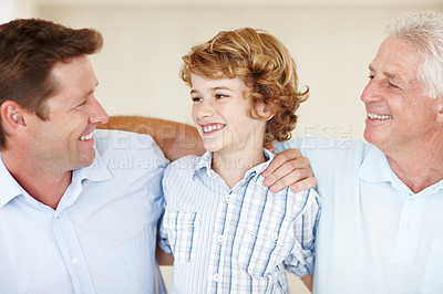 Buy stock photo Boy, love and hug for dad or grandpa in home, support and happy for together generations in lounge. Male person, care and smile in childhood, embrace and vacation for bonding or security in house