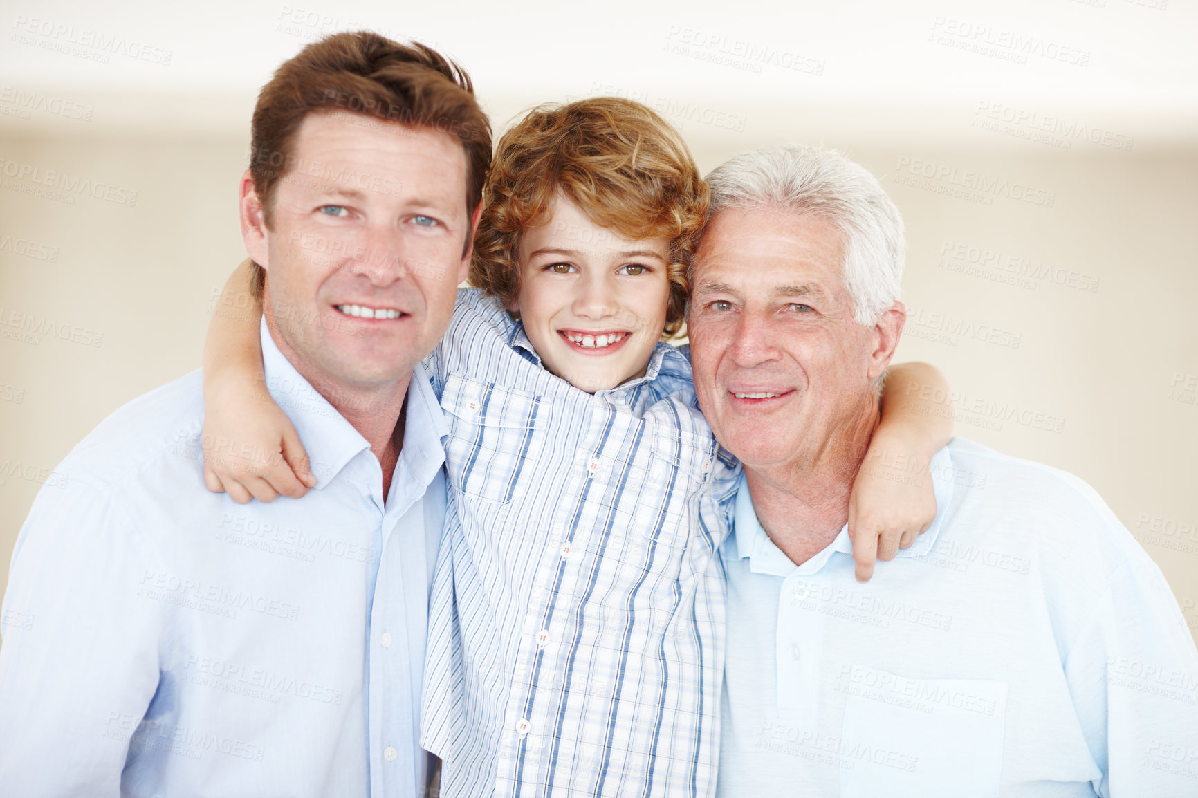 Buy stock photo Cropped portrait of a young boy standing with his father and grandfather