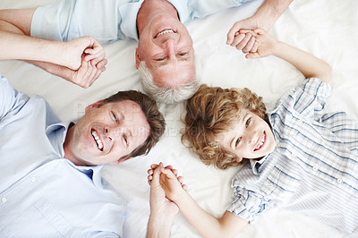 Buy stock photo Portrait of grandpa, dad and child on bed holding hands for bonding, relationship and generations. Family home, happy and above of grandfather, father and young boy for love, relax and fun on weekend
