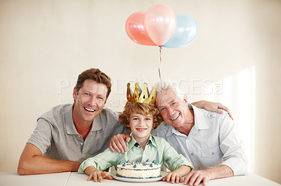Buy stock photo Shot of a happy birthday boy sitting with his father and grandfather