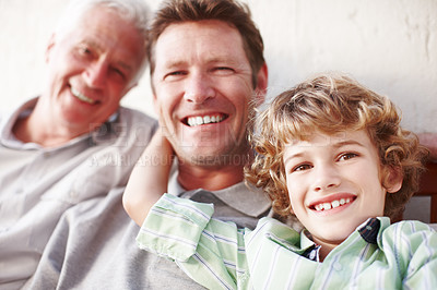 Buy stock photo Cropped portrait of a handsome man sitting with his father and his son