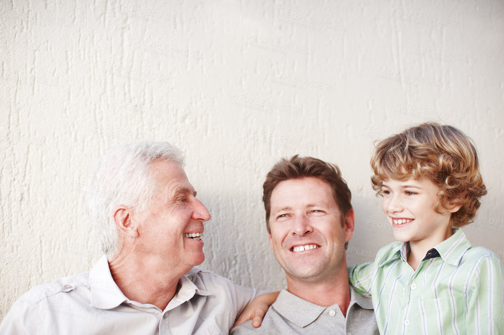 Buy stock photo Hug, father and grandfather or son with smile for bonding, love or relax with generations by wall. Happy family, men or boy child in home for support, mockup space or embrace with confidence or pride