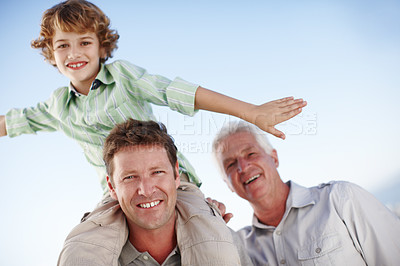 Buy stock photo Portrait of grandpa, father and child by blue sky for bonding, relationship and relax together. Family, fun and grandfather, dad and young boy on shoulders for holiday, vacation and weekend outdoors
