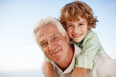 Buy stock photo Piggyback, face of grandfather with child and happy outdoors in blue sky. Portrait of family love, quality time and cheerful grandparent with young boy outside in nature for freedom or summer holiday