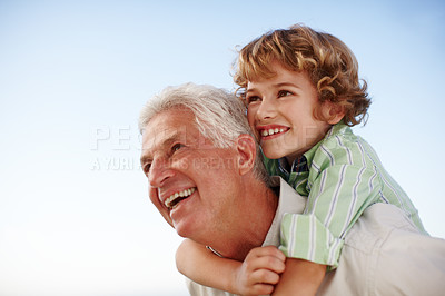 Buy stock photo Happy, blue sky and child on shoulder of grandfather for bonding, relationship and relax together outdoors. Family, nature and grandpa with young boy on summer holiday, vacation and weekend at park