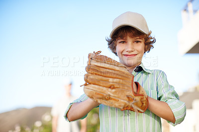 Buy stock photo Cropped portrait of a young boy playing baseball in the yard with his father in the background
