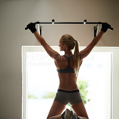 Buy stock photo Rearview s of a beautiful young woman doing chin-ups