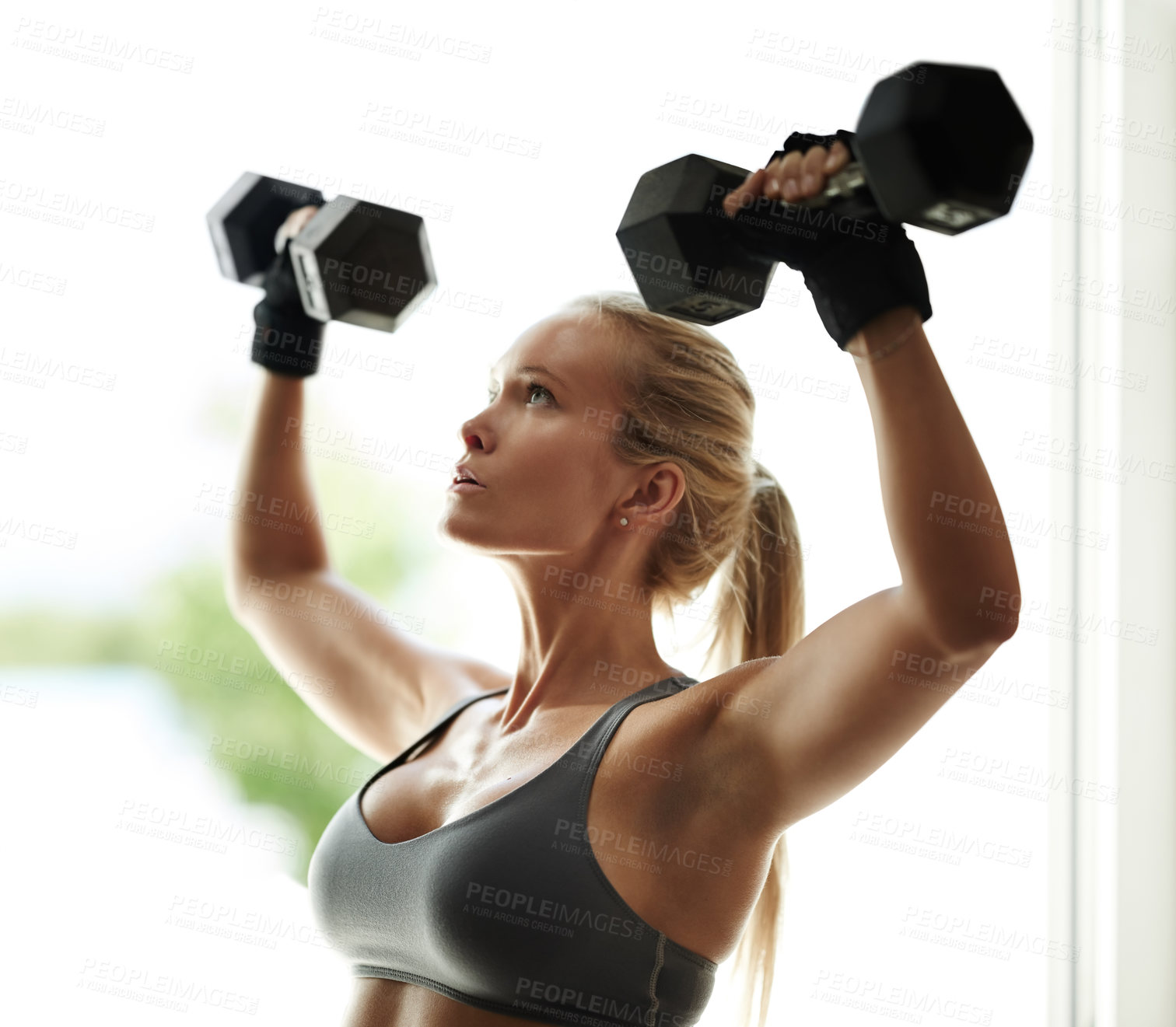 Buy stock photo Shoulder press, gym and woman with dumbbells for fitness, workout and exercise for arms or health. Development, serious and girl athlete lifting weights for sports, body training or muscle growth