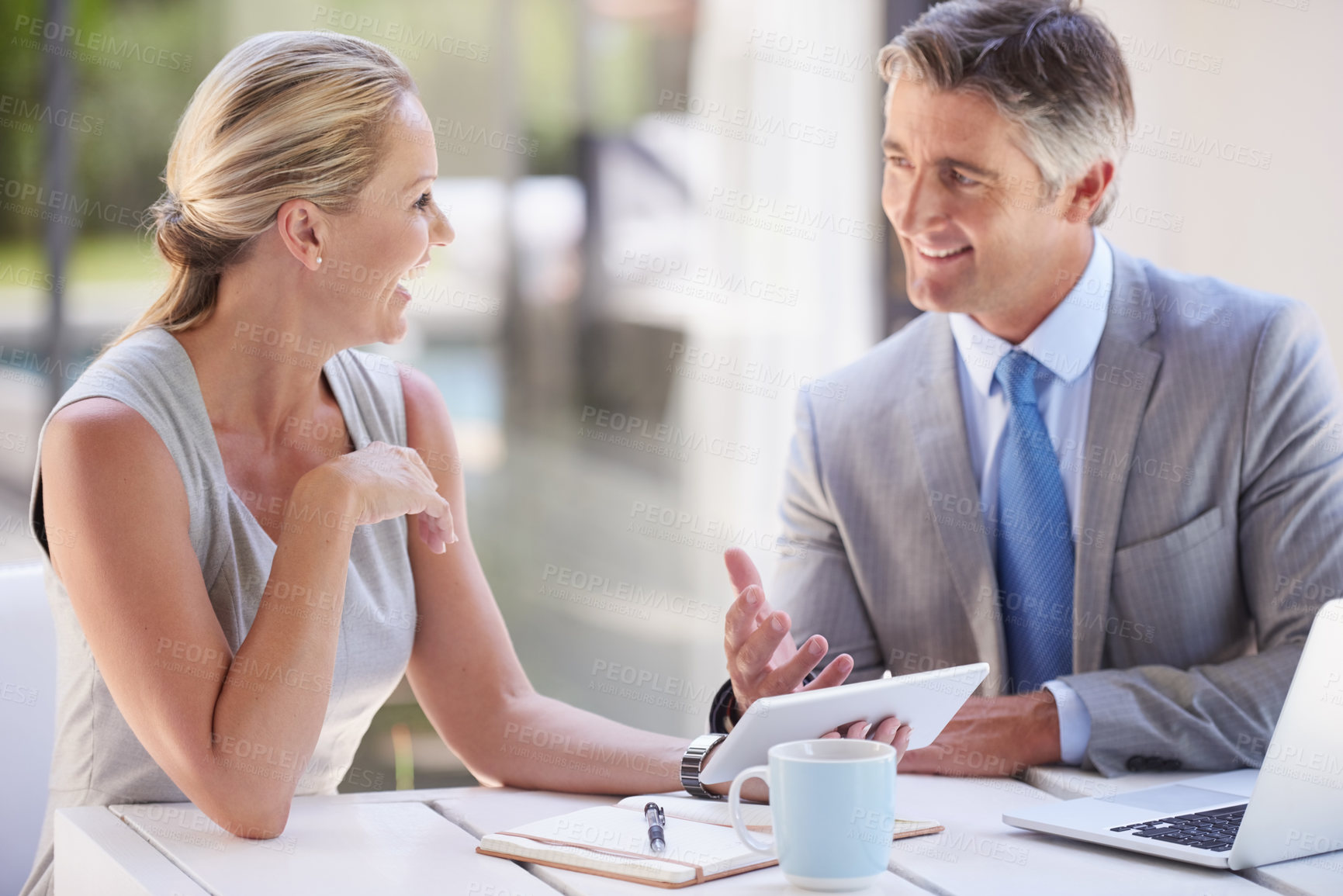 Buy stock photo Businessman, woman and speaking with tablet in office for performance evaluation, digital and financial statement. People, management accountants and conversation for budget, cost and expense control