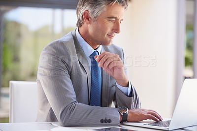 Buy stock photo Cropped shot of a handsome businessman in the office