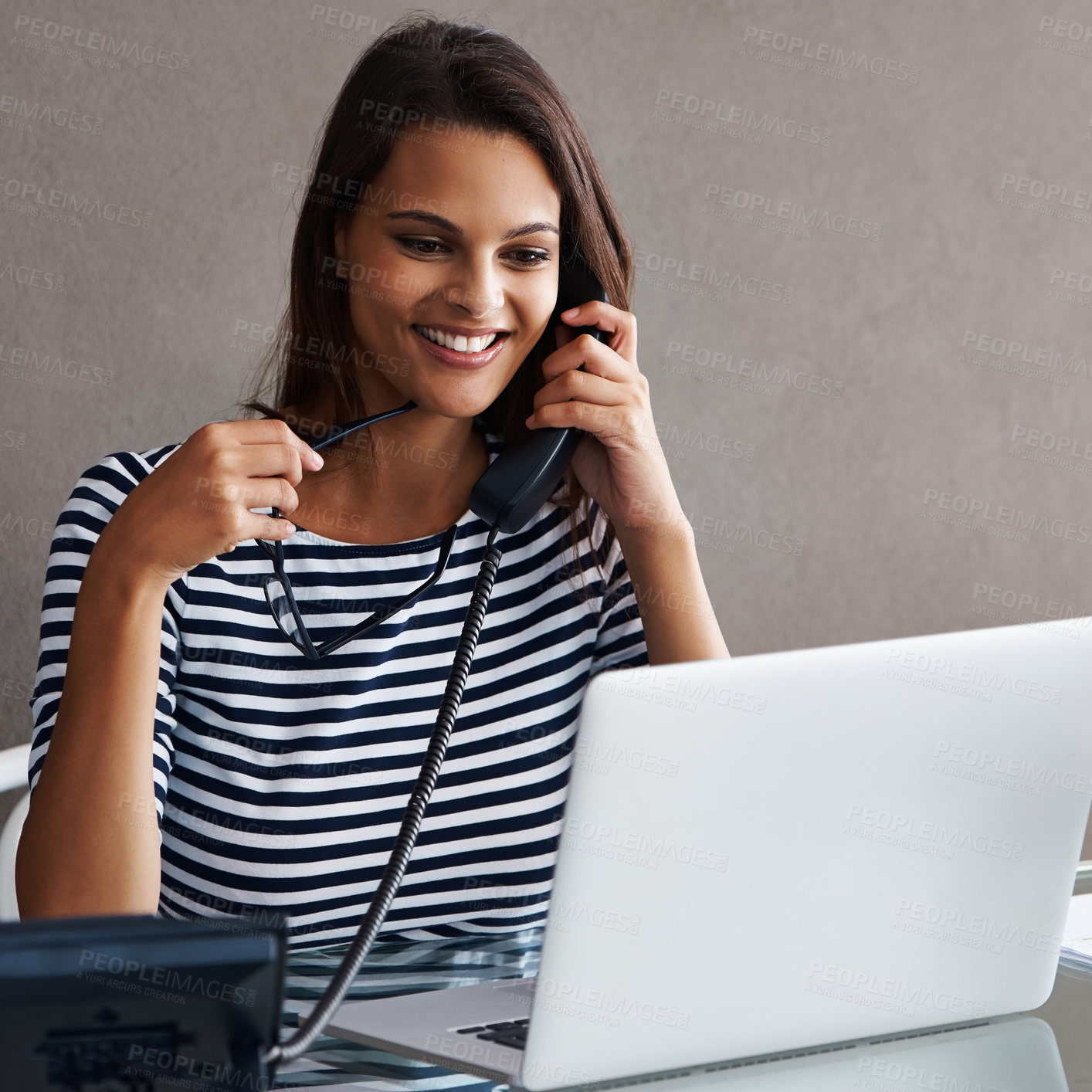 Buy stock photo Telephone, smile and business woman with laptop in conversation, talk or listening to contact with glasses in startup office. Landline, computer or secretary on call, receptionist or creative at desk