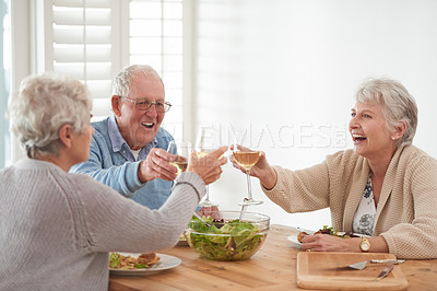 Buy stock photo Wine, toast and senior friends at lunch in home with smile, celebration and bonding in retirement. Food, drinks and cheers with glass, old man and women at dinner table together for happy brunch.