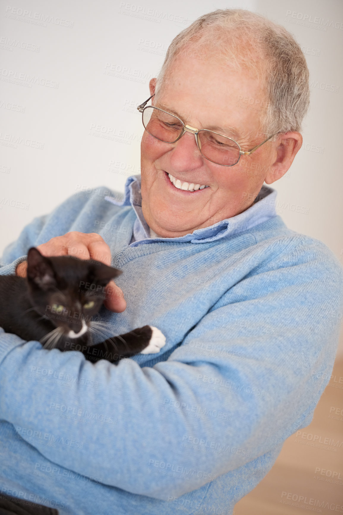 Buy stock photo Happy, home and old man with a cat, smile and love with joy and caring with support and relaxing. Pensioner, apartment or elderly man with animal and playing with a pet and bonding together in lounge