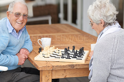 Buy stock photo Happy, game and senior couple with chess together in retirement to relax on holiday or vacation. Elderly, man and woman outdoor with smile for winning competition, checkmate or activity with strategy