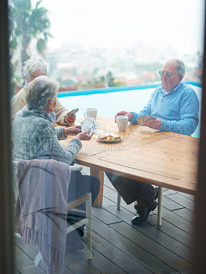 Buy stock photo Senior people, friends and play cards at table at home, bonding or eating cookies to relax at patio outdoor. Elderly group, poker and game together for retirement, social gathering or drinking coffee