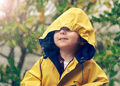 Buy stock photo Child, rain and raincoat protection in winter for fashion, jacket or cold weather outdoor. Little boy, male toddler and kid in drizzle by tree, bokeh or environment with windbreaker for chilly season