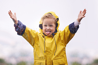 Buy stock photo Winter, raincoat and a girl playing in the water outdoor alone, having fun during the cold season. Kids, rain or wet with an adorable little female child standing arms outstretched outside in the day
