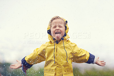 Buy stock photo Winter, raincoat and a girl playing in the rain outdoor alone, having fun during the cold season. Kids, water or wet with an adorable little female child standing arms outstretched outside in the day