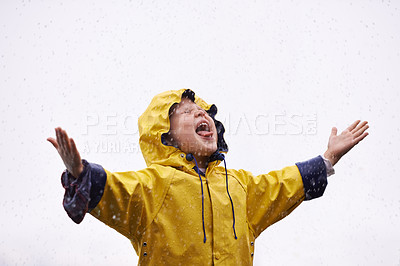 Buy stock photo Girl outdoor, rain and playing in space for mockup with tongue, happiness or winter fashion. Female child, raincoat or play with water, open palm or excited face on adventure with freedom in mock up