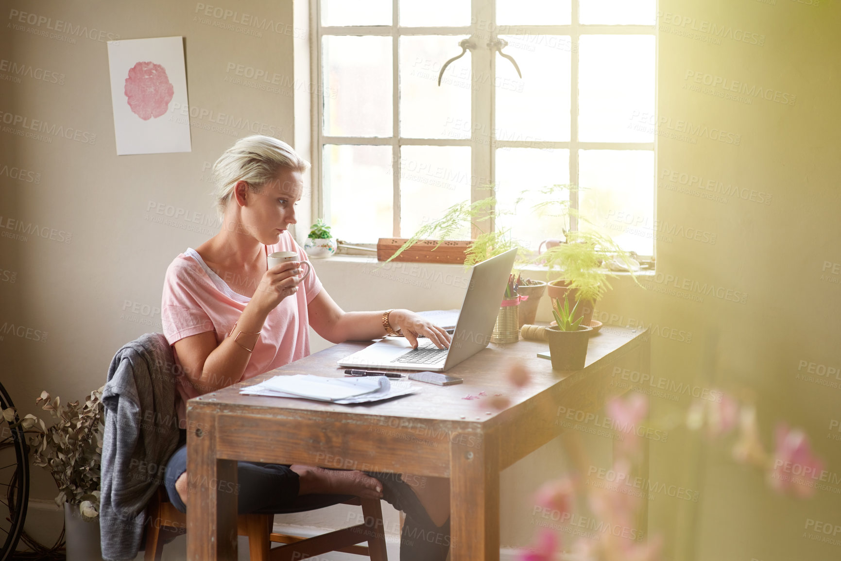 Buy stock photo Shot of a female designer working on her laptop at home