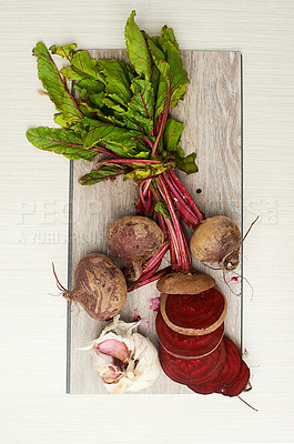 Buy stock photo Fresh, food and nutrition in beetroot, garlic and counter top in kitchen or studio. Healthy, eating and recipe for wellness, health and cuisine with organic, vegetables and cooking for meal prep