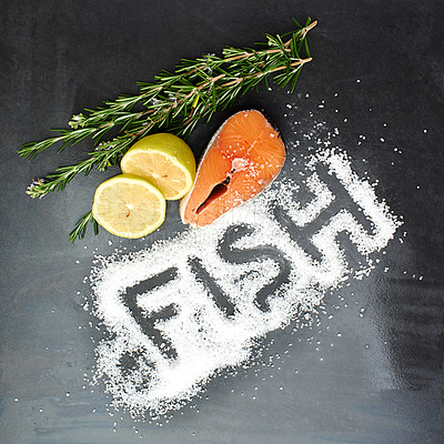 Buy stock photo Salmon, herbs and seasoning on table top for menu development, nutrition and wellness in restaurant. Fish, salt and protein in studio for health, diet and ingredients for cooking on dark background. 