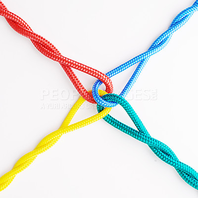 Buy stock photo Rope, knot and color tied in studio for security with equipment for support with white background. Olympics, unity and collaboration with safety for strength in cooperation for together with string