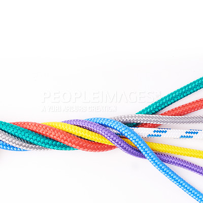 Buy stock photo Colorful ropes knotted together isolated with a white background. Connected ropes with many different colors tied, linked or twisted together. Mixed up and falling apart when being degraded