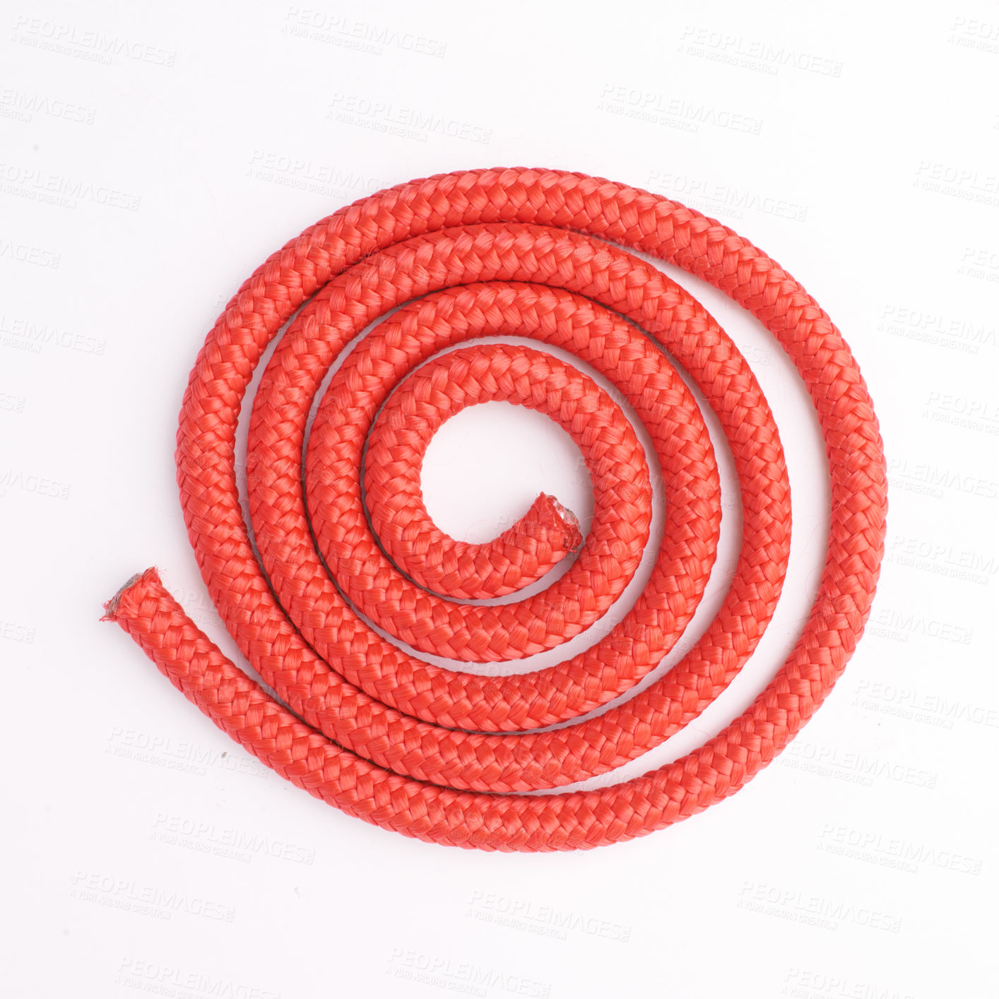 Buy stock photo Above view of coiled red rope isolated against a white background in studio with copyspace. Nylon texture and detail bound in a circle. Aerial view of closeup and zoomed in pattern of spiral object