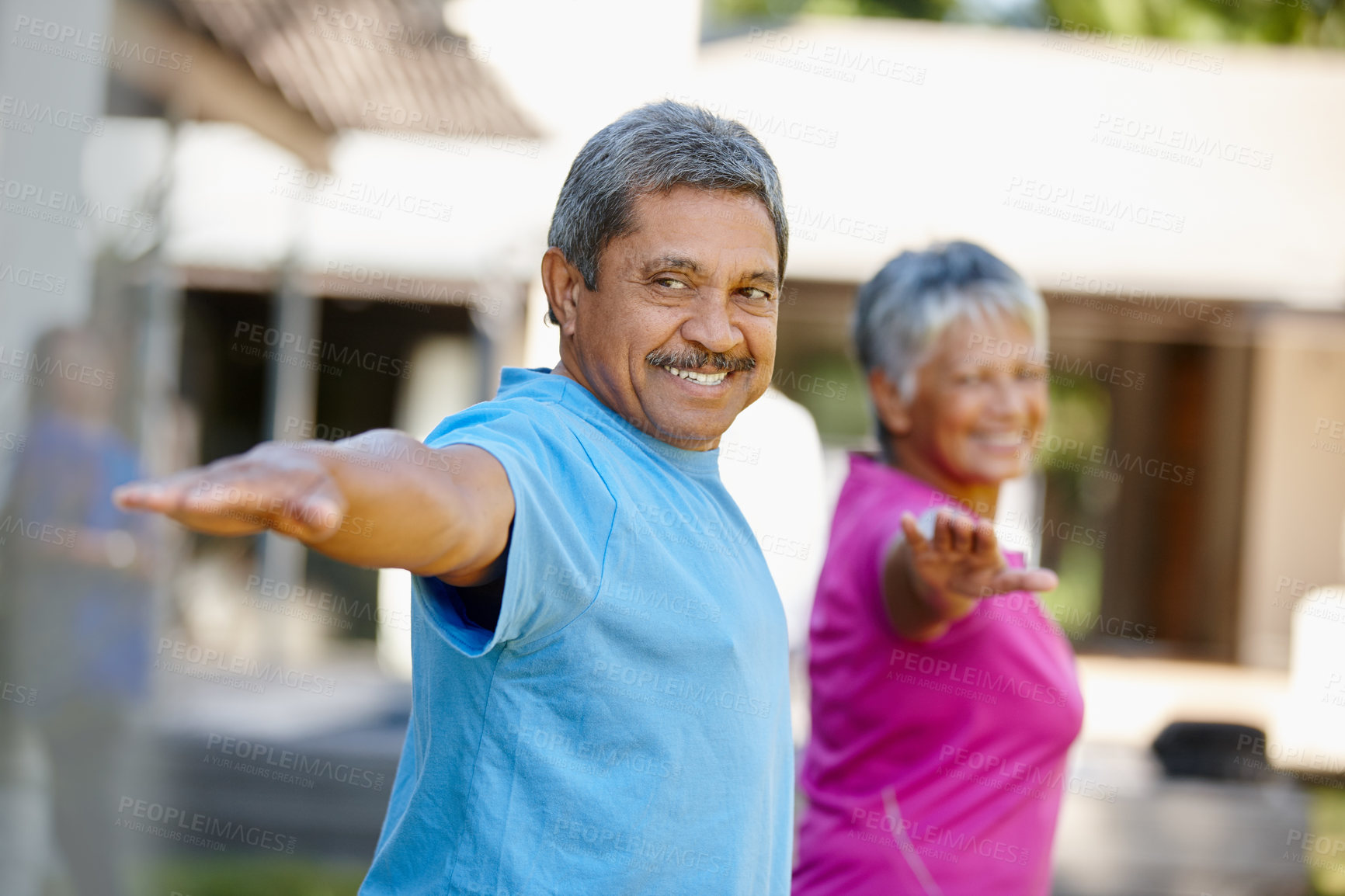 Buy stock photo Portrait of a mature couple exercising together in their backyard