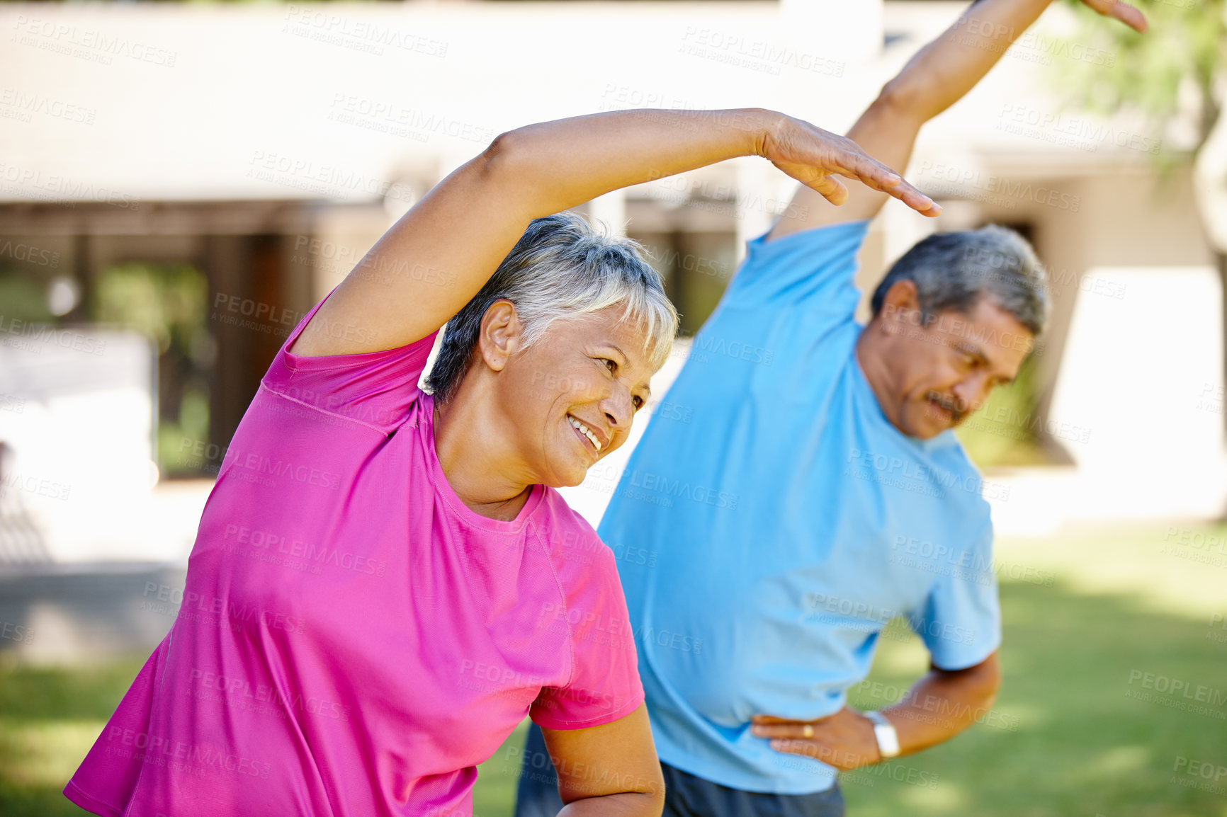 Buy stock photo Shot of a mature couple exercising together in their backyard