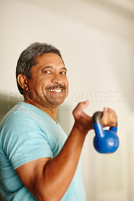 Buy stock photo Cropped shot of a mature man lifting dumbbells