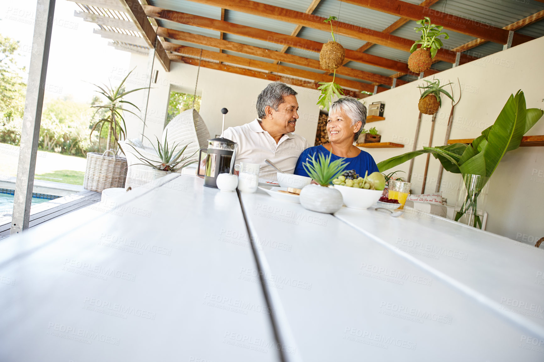 Buy stock photo Shot of a happy senior couple enjoying a leisurely breakfast together at home