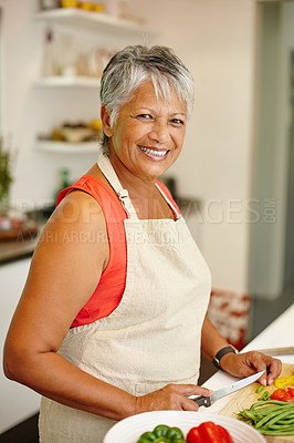 Buy stock photo Portrait of a happy senior woman cooking a healthy meal at home