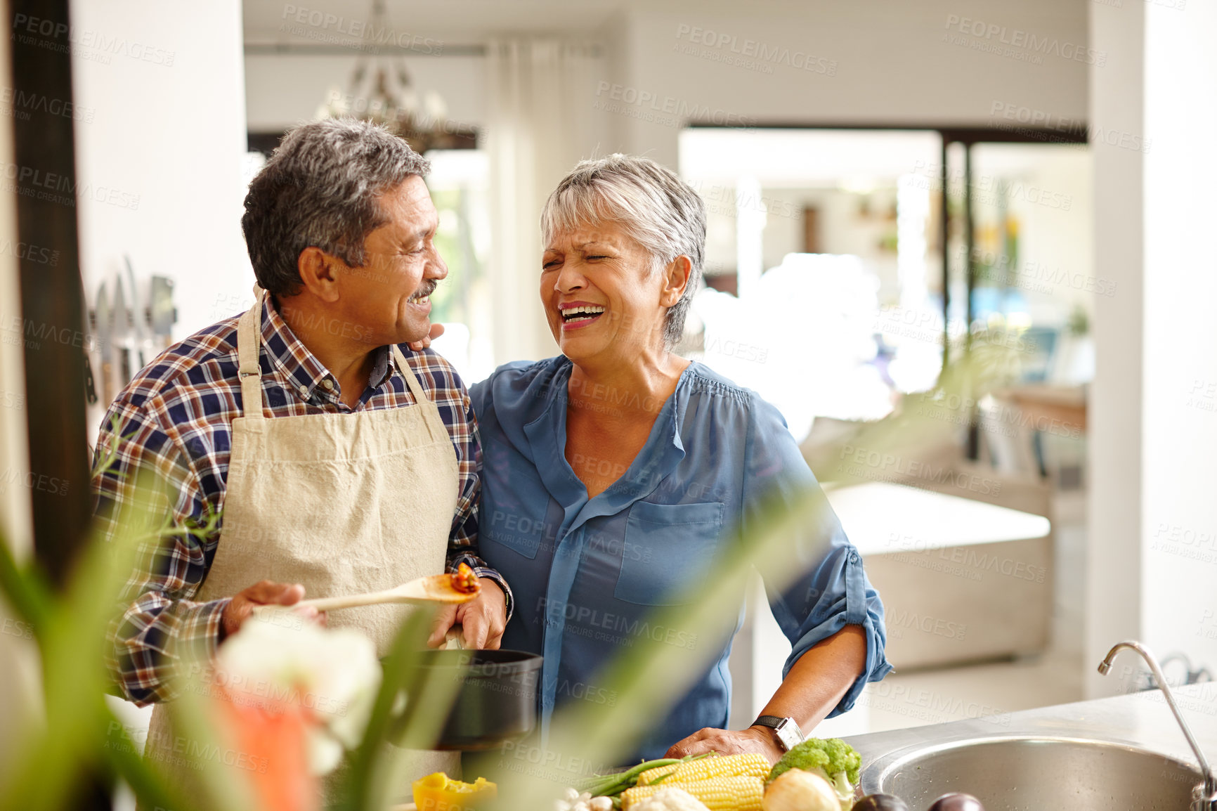 Buy stock photo Shot of a happy senior couple cooking a healthy meal together at home