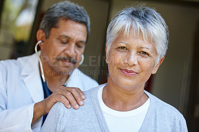 Buy stock photo Portrait of a senior woman getting a checkup from her doctor at home