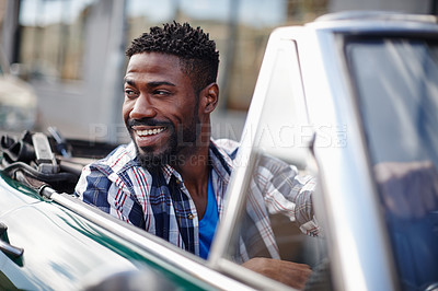 Buy stock photo Shot of a happy young man driving in his convertible