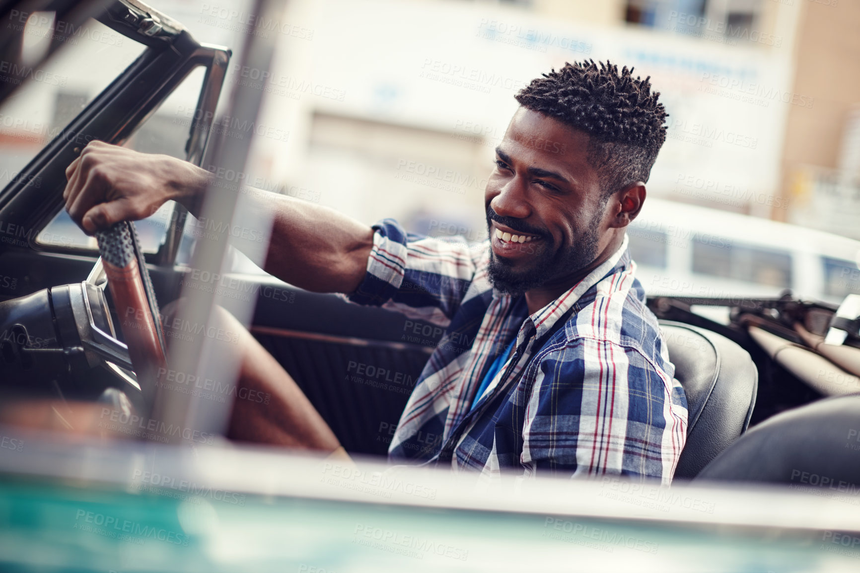 Buy stock photo Shot of a happy young man driving in his convertible