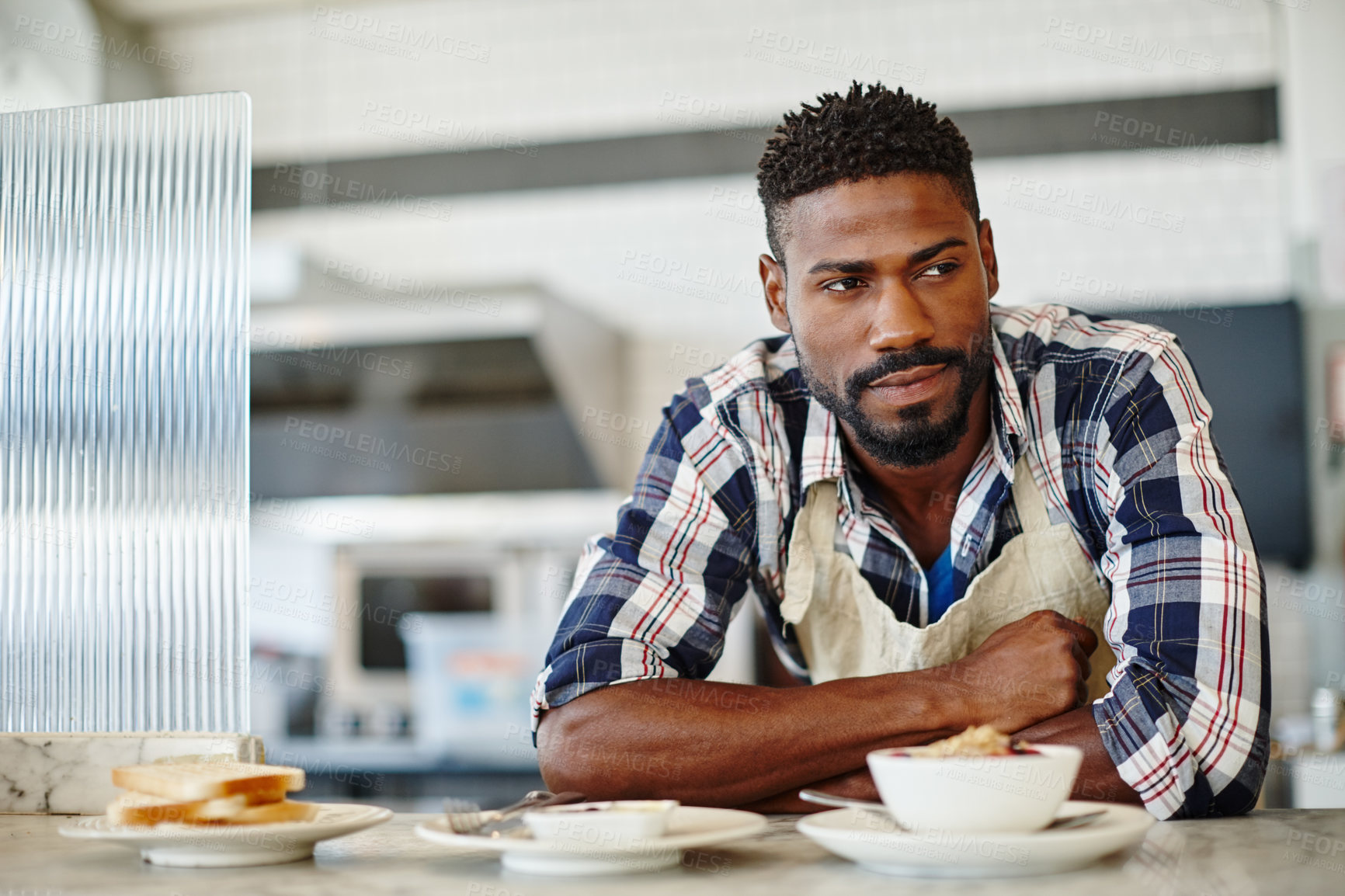 Buy stock photo Cropped shot of a handsome young man working in a coffee shop