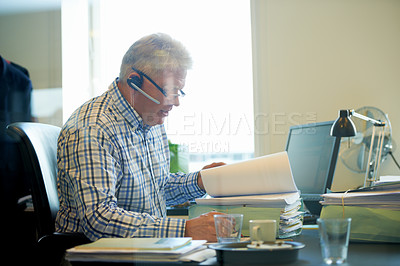 Buy stock photo Senior businessman, documents and headphones in call center for communication or online advice at office. Mature man, consultant or agent reading paperwork for legal assistance or help at workplace