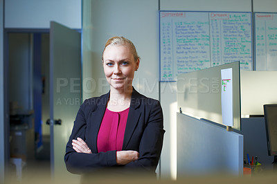Buy stock photo Portrait of an attractive businesswoman standing with her arms crossed in the office