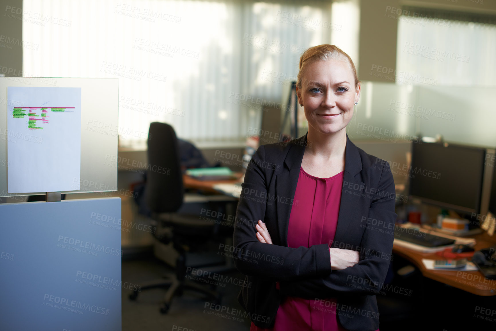 Buy stock photo Portrait of an attractive businesswoman standing with her arms crossed in the office