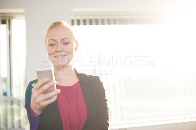 Buy stock photo Cropped shot of an attractive businesswoman using he cellphone on the office